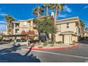 A well maintained building with a designated parking spot, set against a blue sky with palm trees at 7127 S Durango Dr # 310, Las Vegas, NV 89113
