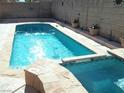 An inviting in-ground swimming pool is surrounded by a brick-paved patio, perfect for outdoor relaxation at 728 Brown Breeches Ave, North Las Vegas, NV 89081
