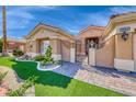 Charming single-story home showcasing a beautifully landscaped yard and a decorative wrought iron gate at 7311 Chaparral Cove Ln, Las Vegas, NV 89131