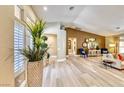 Spacious living room with vaulted ceilings, light wood floors, and stylish decor at 7311 Chaparral Cove Ln, Las Vegas, NV 89131