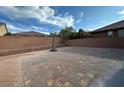 Large brick backyard, perfect for entertaining, includes a basketball hoop and privacy wall at 777 Star Apple Ln, Las Vegas, NV 89178