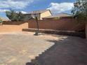 Spacious backyard featuring a basketball court and brick retaining walls for landscaping at 777 Star Apple Ln, Las Vegas, NV 89178