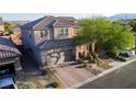Beautiful home with tile roof, brick driveway, mature landscaping, and mountain views at 777 Star Apple Ln, Las Vegas, NV 89178