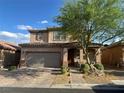 Charming two-story home featuring a brick driveway and a well-manicured front yard at 777 Star Apple Ln, Las Vegas, NV 89178