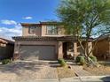Charming two-story home featuring a brick driveway and a well-manicured front yard at 777 Star Apple Ln, Las Vegas, NV 89178