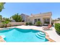 Inviting backyard featuring a private pool, lounge chair, and mature landscaping at 8312 Raphael Ct, Las Vegas, NV 89129