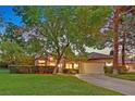Inviting single-story home with mature trees, a lush lawn, and a two-car garage, creating a warm and welcoming curb appeal at 8370 Plum Creek Ct, Las Vegas, NV 89113