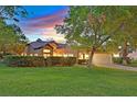 Charming single-story home with well-manicured front lawn, mature landscaping, and an attached two-car garage at 8370 Plum Creek Ct, Las Vegas, NV 89113