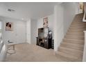 Bright living room featuring a carpeted floor, a staircase, and neutral walls at 9053 Starling Wing Pl, Las Vegas, NV 89143