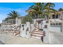 A picturesque front entrance with a rock wall, and brick and stucco accents at 953 Pyrite Ave, Henderson, NV 89011