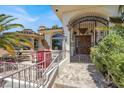 Charming Mediterranean-style entrance with wrought iron gate and decorative accents at 953 Pyrite Ave, Henderson, NV 89011
