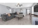 Spacious living area with a plush sectional sofa and ample natural light at 9730 Cluny Ave, Las Vegas, NV 89178