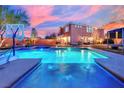 Stunning backyard pool with vibrant blue lighting and a fun basketball hoop at 9906 Stiges St, Las Vegas, NV 89178
