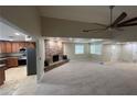 Inviting living room with a vaulted ceiling, open floor plan, stone fireplace, and kitchen view at 1006 Bel Air Cir, Las Vegas, NV 89109
