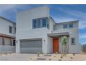 Contemporary two-story home with an orange front door, featuring low maintenance desert landscaping at 10448 Smokey Mariposa, Las Vegas, NV 89166