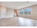 Spacious living room with large windows and wood-look floors at 10448 Smokey Mariposa, Las Vegas, NV 89166