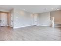 Bright and airy living room featuring neutral walls and wood-look floors at 10448 Smokey Mariposa, Las Vegas, NV 89166