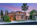Elegant two-story home boasting mature palm trees and a well-manicured lawn at 11271 Winter Cottage Pl, Las Vegas, NV 89135