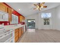 Bright kitchen featuring light wood cabinets and tiled floor at 1230 Pagentry Dr, North Las Vegas, NV 89031