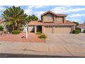 Two-story home featuring a terracotta roof, desert landscaping, and a two-car garage at 1587 Bermuda Dunes Dr, Boulder City, NV 89005