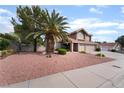 Charming two-story home with well-maintained desert landscaping and an attached two-car garage at 1587 Bermuda Dunes Dr, Boulder City, NV 89005