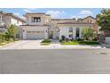 Stunning two-story home with a three-car garage, manicured lawn, and elegant facade at 1990 Country Cove Ct, Las Vegas, NV 89135