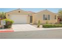 Inviting single-story home with a two-car garage, easy-care desert landscaping, and a neutral exterior at 2008 Royal Gardens Pl, North Las Vegas, NV 89084