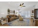 Inviting living room featuring a ceiling fan, plush sofa, area rug, and sliding glass door at 2616 Red Planet St, Henderson, NV 89044