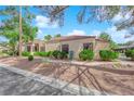 Single-story home featuring desert landscaping with beautiful trees and shrubs at 2714 Bridgepointe Dr, Las Vegas, NV 89121