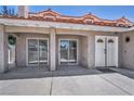 An outdoor patio area featuring sliding glass doors and a decorative front door for easy access at 3421 Rochelle Ct, Las Vegas, NV 89121