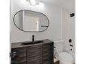 Stylish bathroom featuring decorative vanity, black fixtures, and shower-tub combo at 3622 Covewick Dr, North Las Vegas, NV 89032