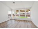 Bright living room with light wood floors and large windows overlooking the backyard at 3622 Covewick Dr, North Las Vegas, NV 89032