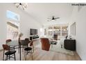 Spacious living room with large windows, modern furnishings, and wood-style flooring at 3622 Covewick Dr, North Las Vegas, NV 89032