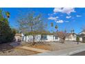 Inviting single-story home with desert landscaping, sidewalk, and mature trees on a sunny day at 3747 N Braewood South Ave, Las Vegas, NV 89120