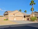 Inviting home featuring a three-car garage, neutral tones, and a well-kept front yard with palm trees at 4016 Mountain Trek St, Las Vegas, NV 89129