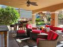 Inviting covered patio with comfortable seating, a ceiling fan, and views of the beautifully landscaped backyard at 4016 Mountain Trek St, Las Vegas, NV 89129