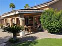 Covered patio featuring an outdoor dining area with a ceiling fan, perfect for relaxing and entertaining guests at 4016 Mountain Trek St, Las Vegas, NV 89129
