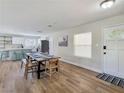 Open-concept dining area featuring modern finishes and wood flooring, seamlessly connecting to the kitchen at 4072 E Harmon Ave, Las Vegas, NV 89121