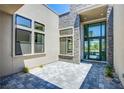 Covered front entrance with stone accents and stylish gray pavers at 4750 Outlook Peak St, Las Vegas, NV 89135