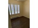 A bedroom showcasing wood floors and a window with stylish shutters at 495 Edgefield Ridge Pl, Henderson, NV 89012