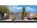 Charming townhome featuring an attached garage and well-maintained landscaping at 5256 Harvest Breeze Rd, Las Vegas, NV 89118