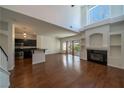 Spacious living room featuring a fireplace, wood floors, and ample natural light at 5256 Harvest Breeze Rd, Las Vegas, NV 89118