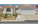 Charming single-story home with a two-car garage, desert landscaping, and tiled roof at 5489 Royal Vista Ln, Las Vegas, NV 89149