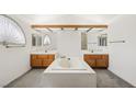 Bright bathroom featuring dual sinks, a tub, and elegant fixtures at 615 Cervantes Dr, Henderson, NV 89014