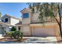 Inviting two-story home featuring a two-car garage and well-maintained landscaping at 6241 Overhang Ave, Henderson, NV 89011