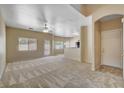 Spacious living room with plush carpet and a ceiling fan at 6241 Overhang Ave, Henderson, NV 89011
