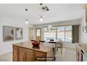 Bright kitchen with granite counters, island, modern lighting, and a view of the pool at 6358 Meadow Lark Ln, Las Vegas, NV 89103