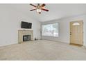 Bright living room featuring tiled floors, a decorative fireplace, and a large window at 6358 Meadow Lark Ln, Las Vegas, NV 89103