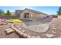 Expansive backyard featuring a patio and gravel area, perfect for outdoor entertaining and relaxation at 6360 Bullring Ln, Las Vegas, NV 89130