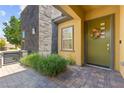 Inviting front entry featuring a decorative wreath, stylish front door and brick walkway at 6810 Silver Crescent St, Las Vegas, NV 89148